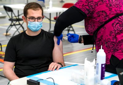 BU student receiving the Moderna COVID-19 vaccine