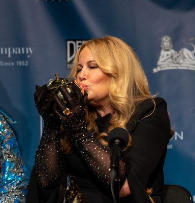Jennifer Coolidge kisses the Pudding Pot during the press conference following the roast.