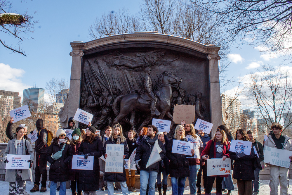 College students rally across the street from the Massachusetts State House, in front of the Robert Gould Shaw memorial.