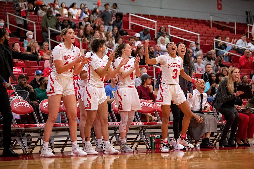 Members of the BU women’s basketball team cheering on the sidelines. The BU Terriers lost a tough 90-80 game against the Boston College Eagles on Sunday despite out-rebounding the Eagles. ELIZA NUESTRO/DFP STAFF