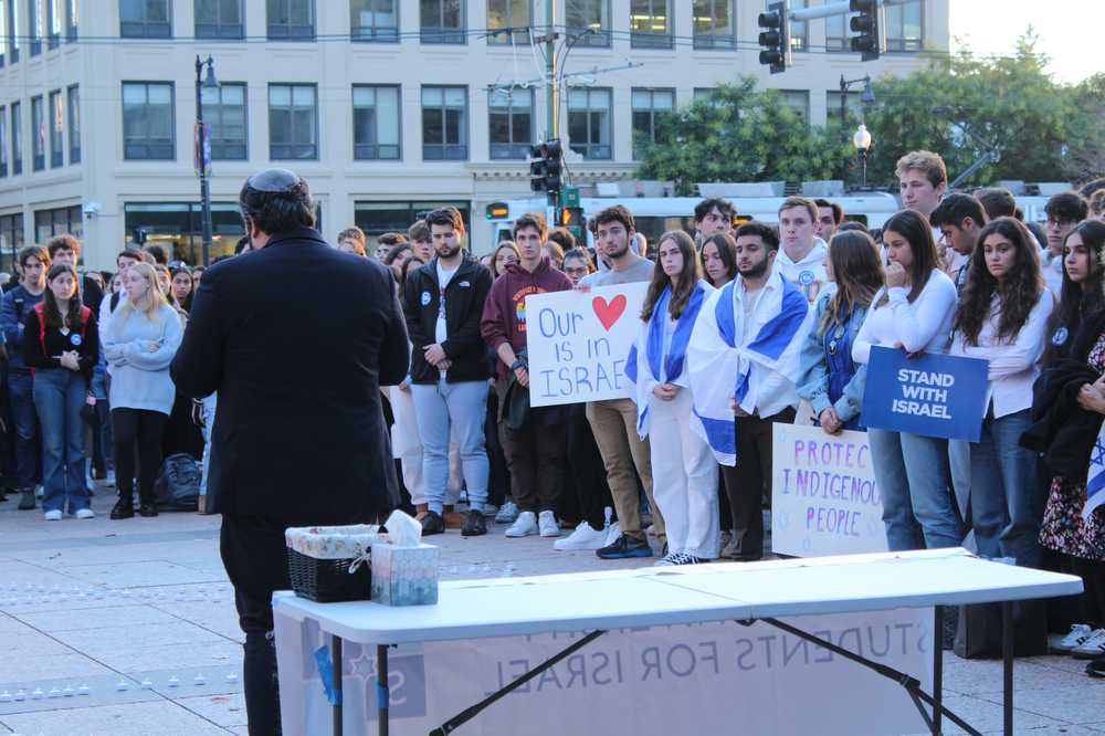 People listen to a speaker at a “Gathering in Solidarity with Israel under Fire” event at Marsh Plaza.