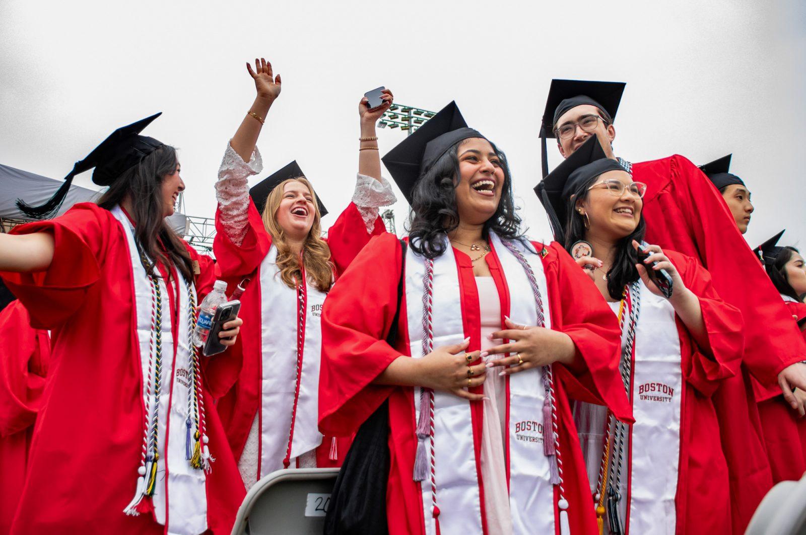 Graduates laugh and wave to the crowd at BU’s commencement ceremony. CLARE ONG/DFP PHOTOGRAPHER