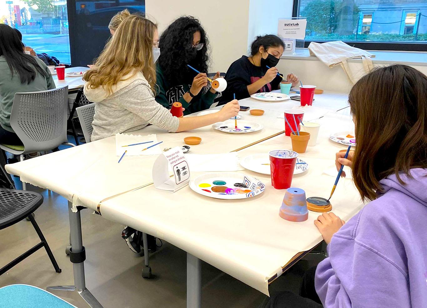 Boston University Arts Initiative partnered with Innovate@BU to put on “Painting and Popcorn” Friday for students to stop by the BUild lab to paint ceramic pots while eating popcorn. EMILY PAULS/ DAILY FREE PRESS STAFF
