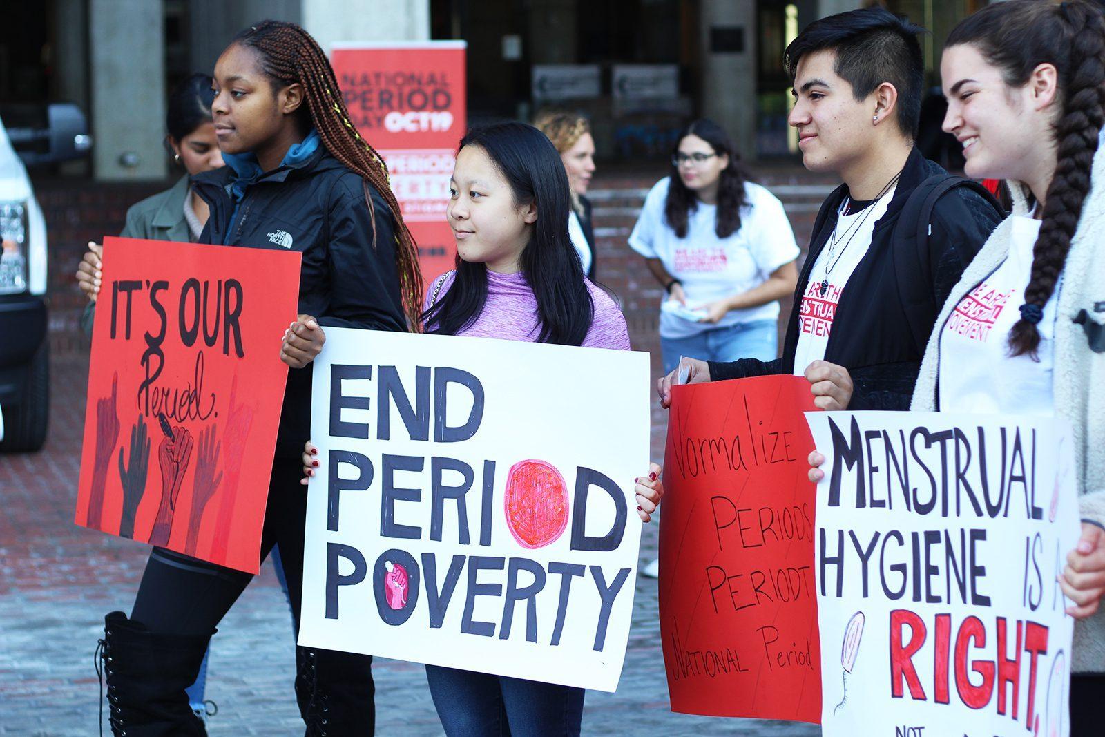 Participants pose with posters at the National Period Day rally hosted in the Boston City Hall Plaza Saturday. HANNAH YOSHINAGA/ DAILY FREE PRESS STAFF