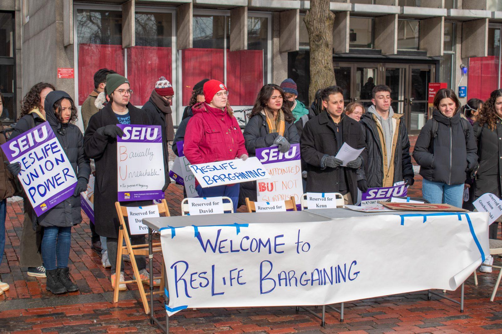 Members of the Boston University Residential Life Union gather behind an empty table representing the delay in contract negotiations for better working conditions at a rally on January 18. The ResLife Union voted to begin a four-day strike Friday at noon to demand better working conditions, including stipends and training for life-saving care. MOLLY POTTER/DFP PHOTOGRAPHER