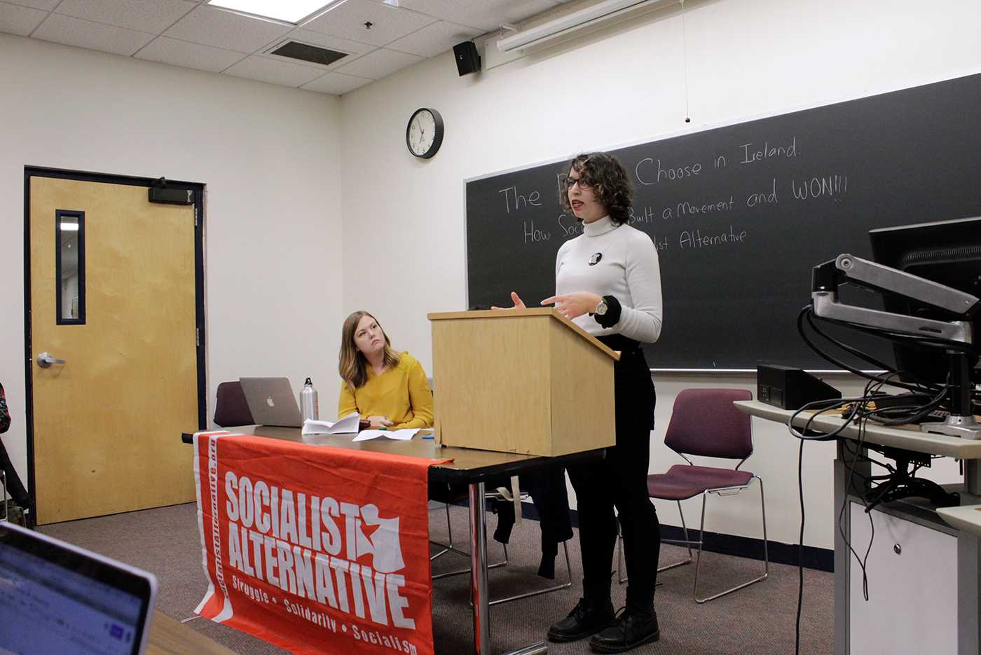 Carey Howard (left) and Myriam Poizat (right) speaking at The Socialist Alternative’s meeting on Feb. 22 at Northeastern University. The Socialist Alternative is a national organization fighting exploitation and injustice in workplaces, communities and campuses. RACHEL SHARPLES/ DAILY FREE  PRESS STAFF