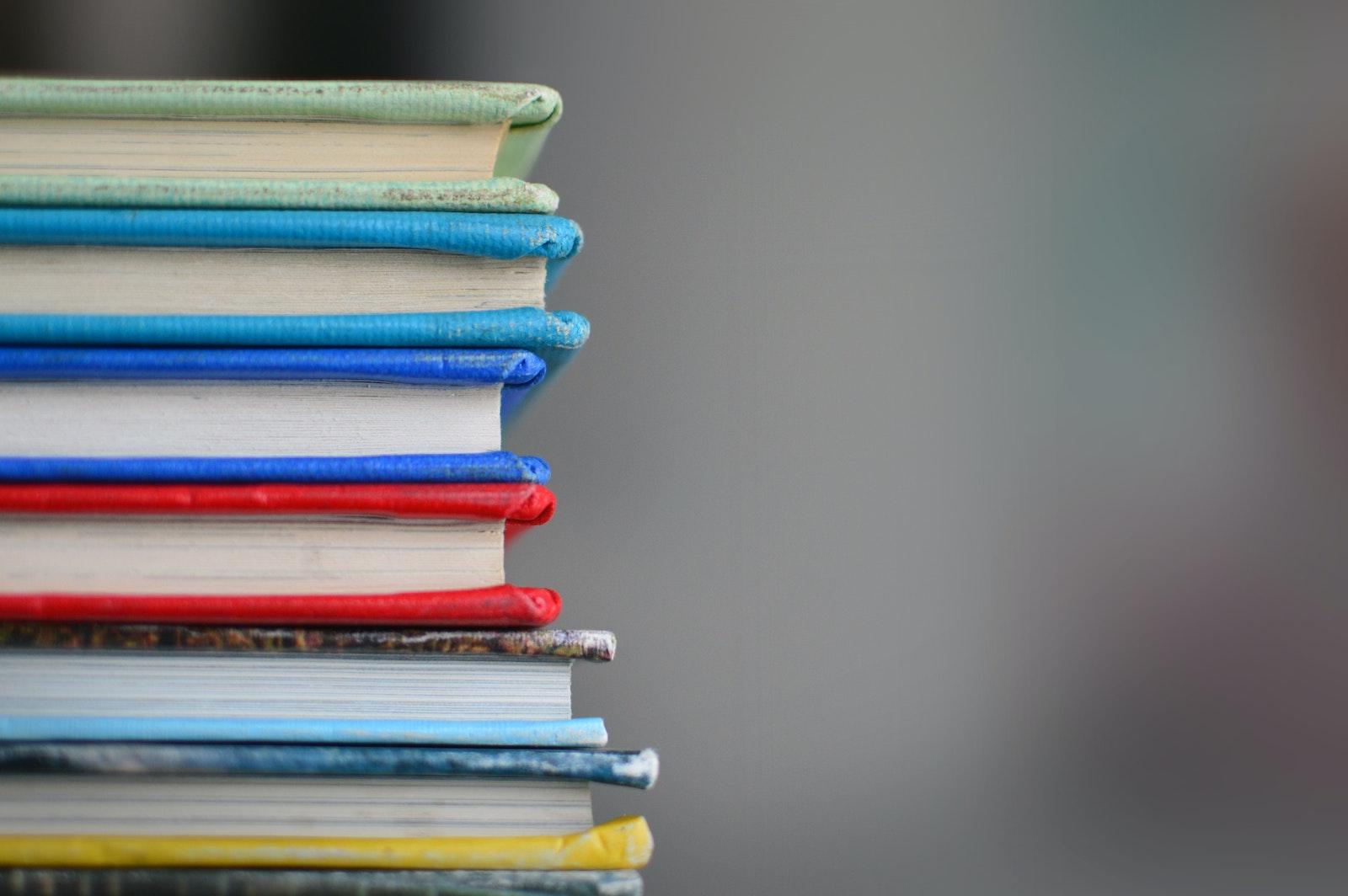 A stack of books. Lynn shares five books that will soon be adapted for television and movies — and that you should read before they do. COURTESY OF KIMBERLY FARMER VIA UNSPLASH
