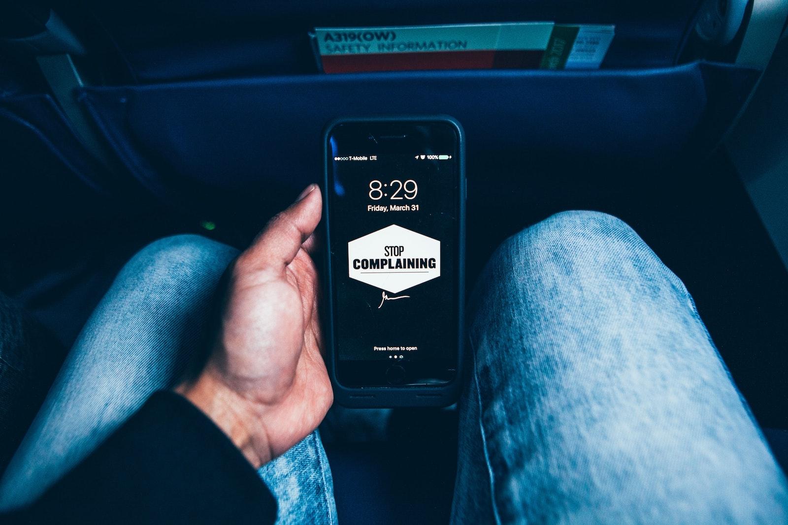 A phone screen reading “Stop Complaining.” Bailey is, self-admittedly, a frequent complainer, and writes about how the implementation of ‘no complaint days’ may help break her habit. COURTESY OF OMAR PRESTWICH VIA UNSPLASH
