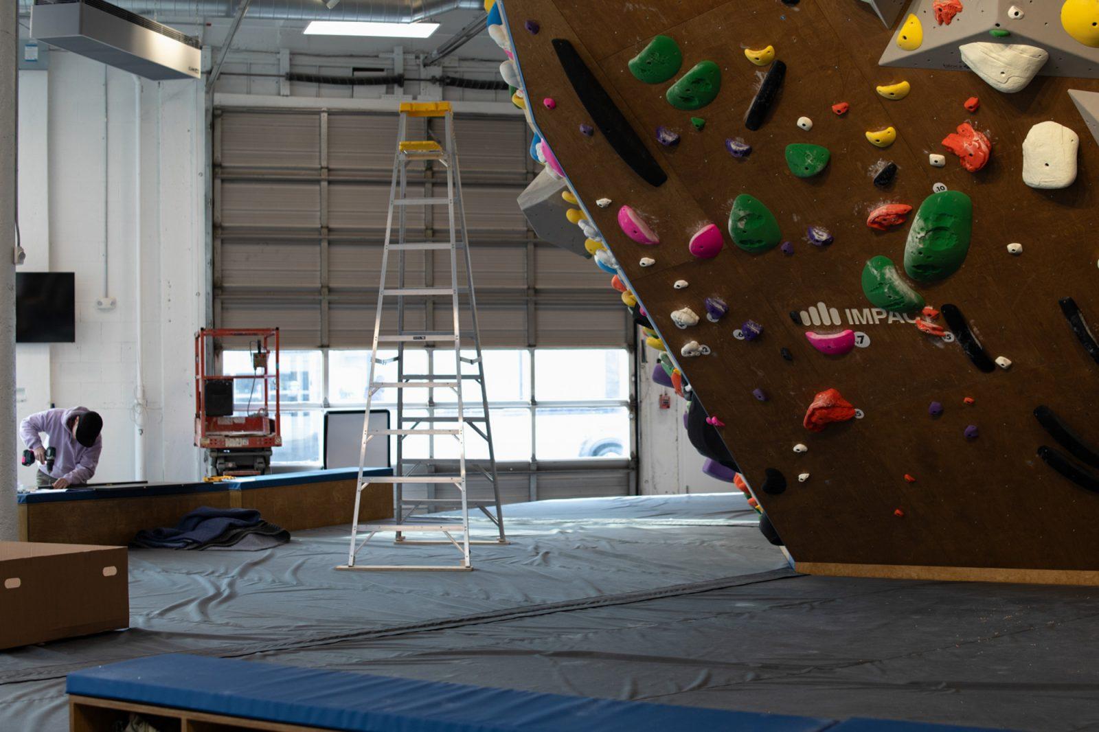 An employee works on renovations at Rock Spot Brookline before its opening this Friday. The Boston University Climbing Club partnered with Rock Spot and will hold practices, as well as events, at this new location. SYDNEY ROTH/DFP PHOTOGRAPHER