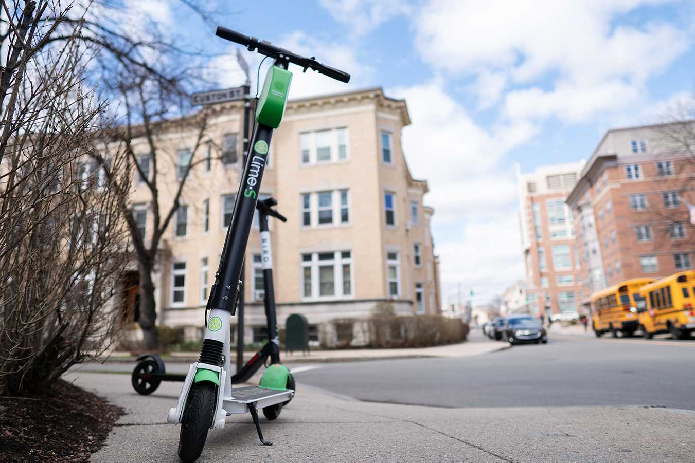 A Lime scooter parked on the sidewalk. The pilot program that allows Limes in Brookline is ending on Nov. 15, with the possibility that electric scooter usage might be extended. SOPHIE PARK/ DFP FILE