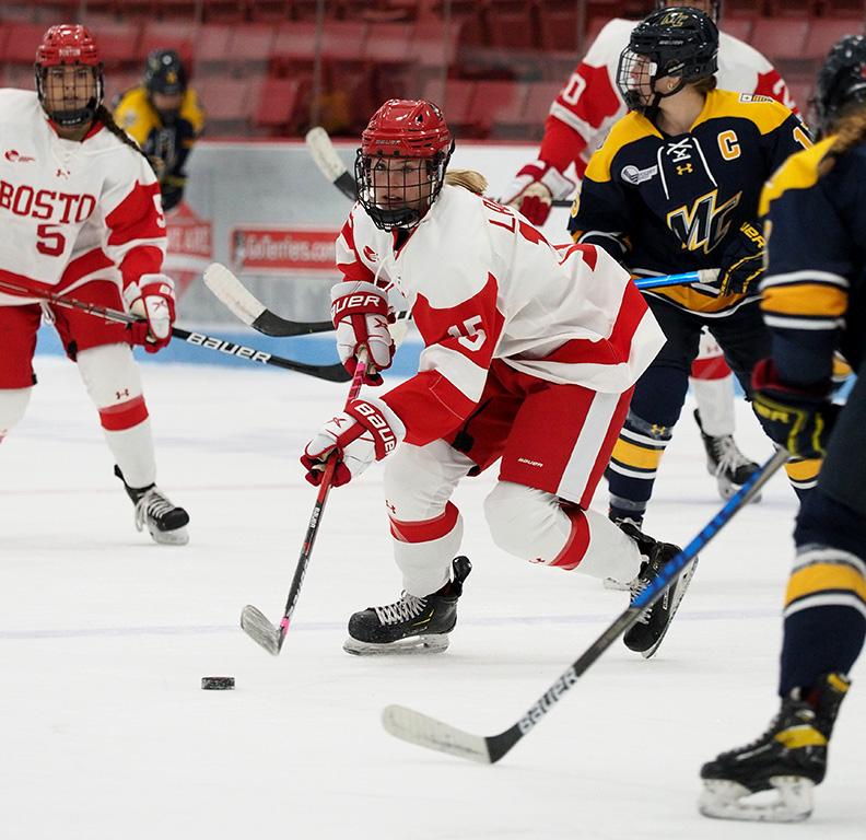 Graduate student defender Ellie Larson skating with the puck in a hockey match against Merrimack College Saturday. The Terriers swept the Warriors this weekend, winning 2-1 Friday in North Andover and 4-1 Saturday at Walter Brown Arena. JEFF TEDI/ DFP STAFF