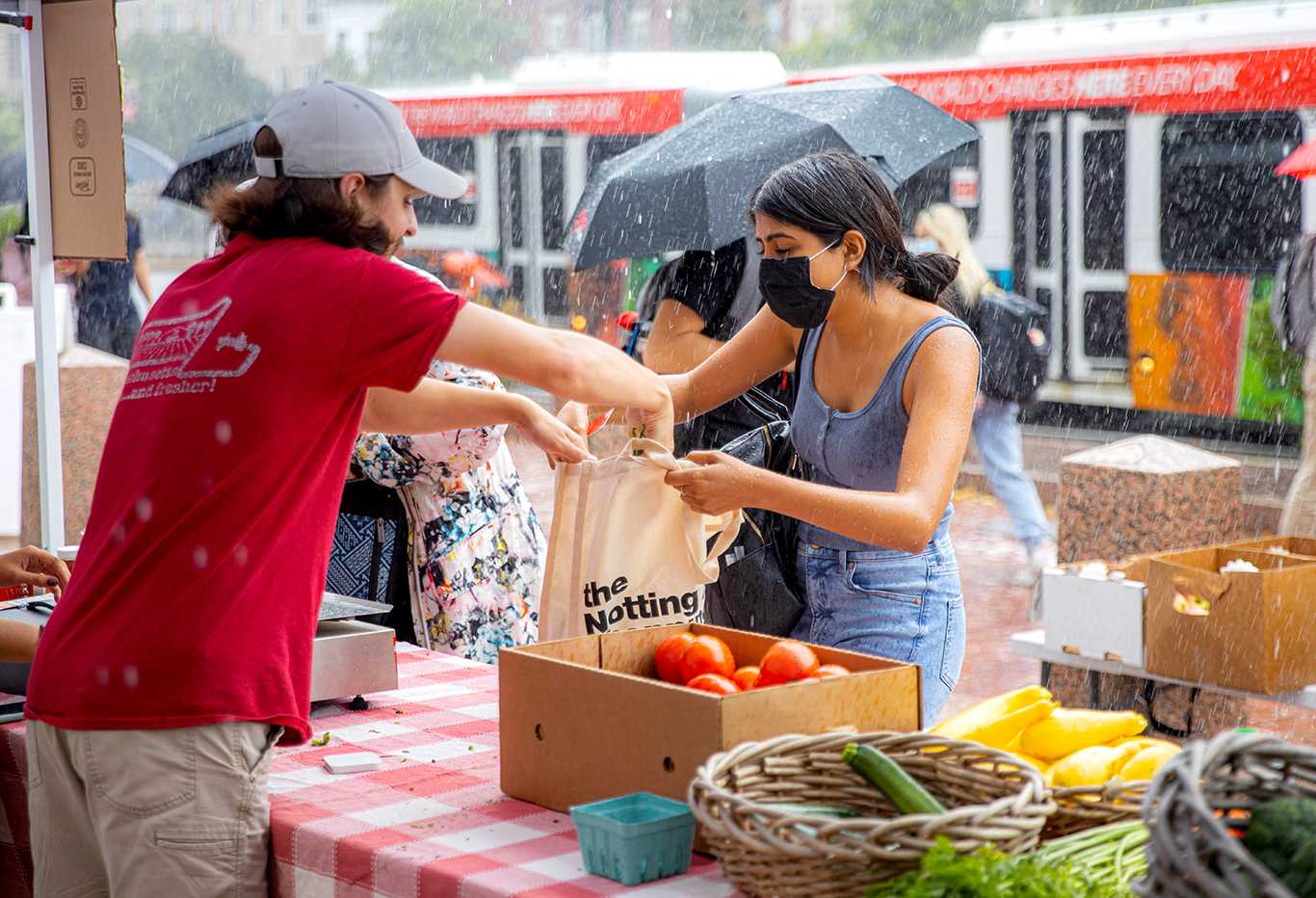student buying produce at sustainability festival