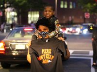 mother and child holding a "please don't kill my son" sign at a breonna taylor protest