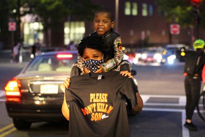mother and child holding a "please don't kill my son" sign at a breonna taylor protest