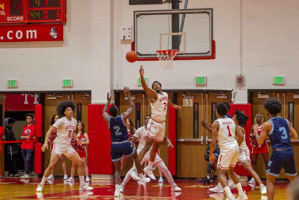 Junior guard Malcolm Chimezie (3) jumps to block a shot in a game against the University of Maine on Wednesday. The Terriers suffered 74-65 loss after falling behind in the final minutes of the game. SEAN YOUNG/DFP PHOTOGRAPHER