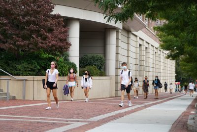 students walk in front of the fitness and recreation center at boston university