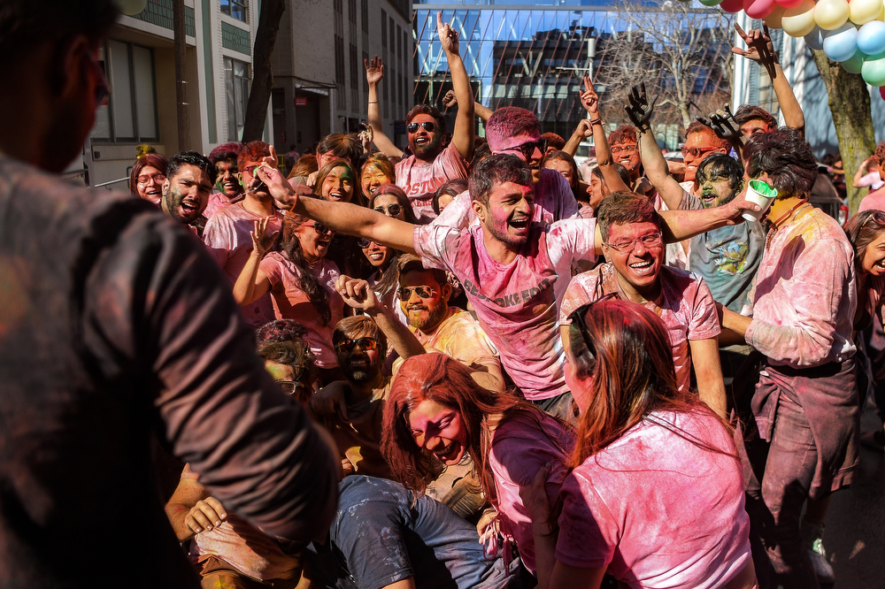 A crowd cheers during Holi.