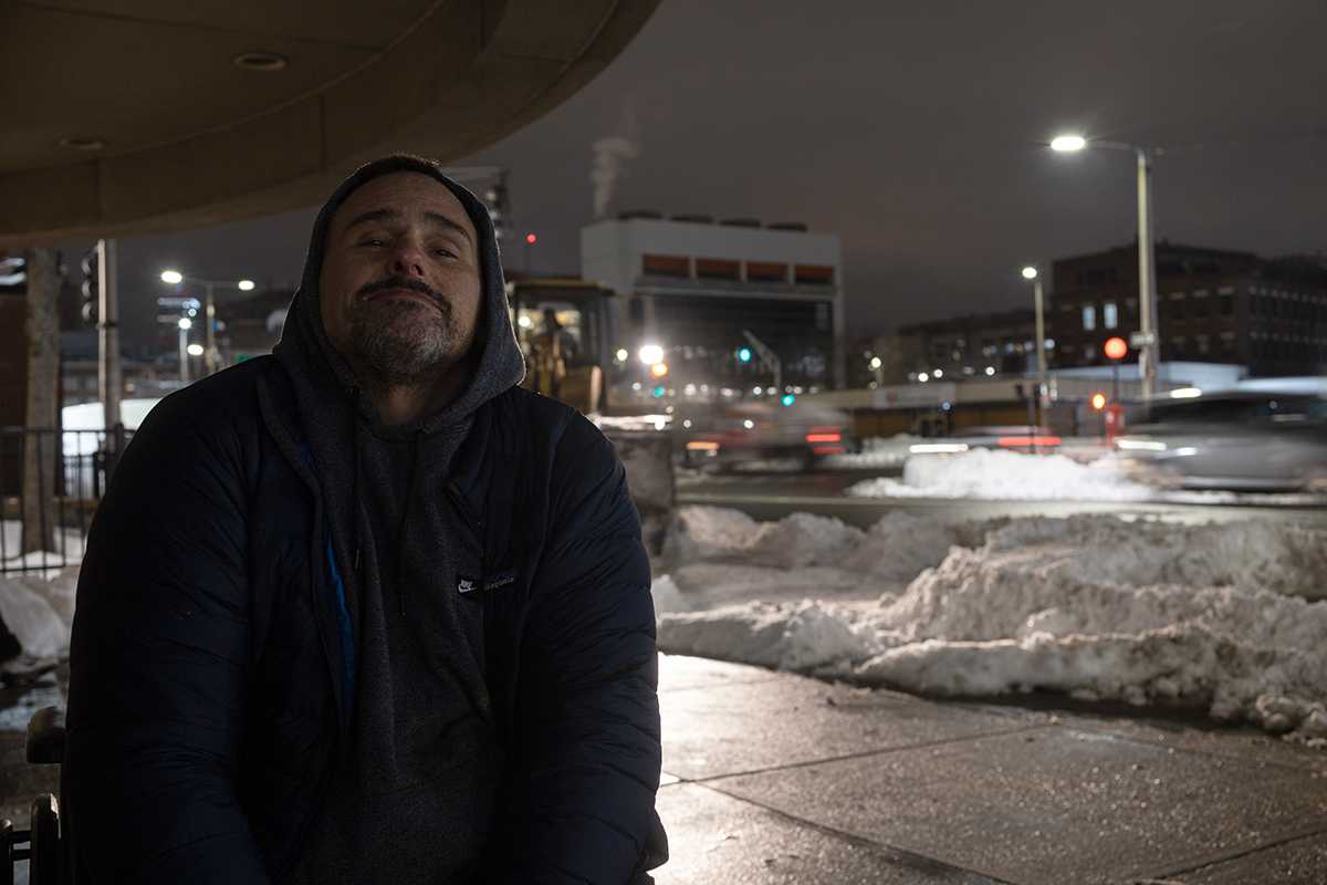 Resident of Methadone Mile, Michael Gavin, who stays in Southampton Street Shelter sits in a wheelchair in front of Best Western Plus Boston Hotel. The blizzard on Jan. 29 closed many businesses’ doors, but Pine Street Inn – one of the shelters that is part of Mayor Michelle Wu’s Mass, and Cass relocation plan – remained open for locals who needed help. KAITO AU/DFP STAFF