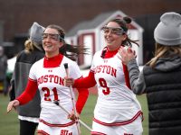 Senior midfielder Jennifer Barry (21) and sophomore defense Madison Vetterlein (9) from the Boston University women’s lacrosse team, pictured in March 2022.