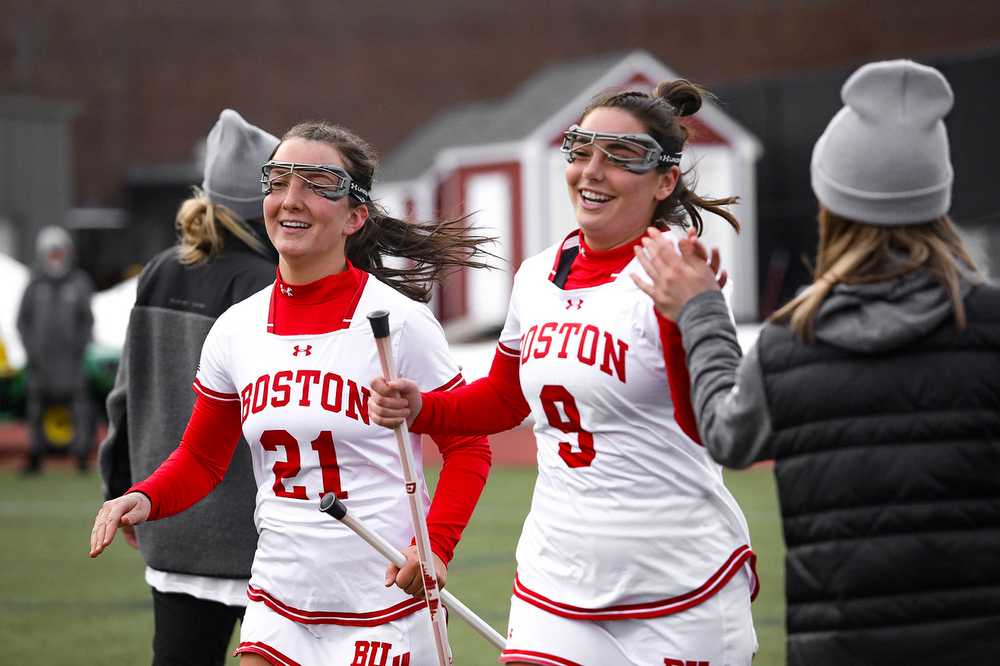 Senior midfielder Jennifer Barry (21) and sophomore defense Madison Vetterlein (9) from the Boston University women’s lacrosse team, pictured in March 2022.