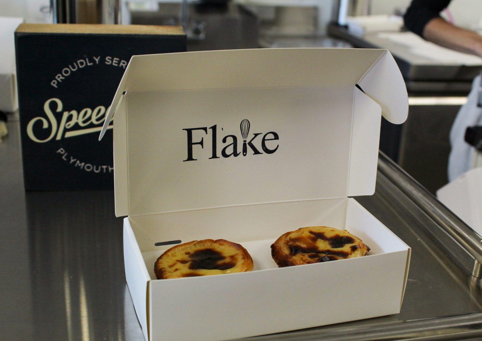 Two Pastel De Natas in a pastry box at Flake Bakery. Flake Bakery, which was founded by Quintino and Stephen Chen and serves authentic Portuguese pastries, opened on Oct. 1. ZIBBY ENGLISH/DFP PHOTOGRAPHER