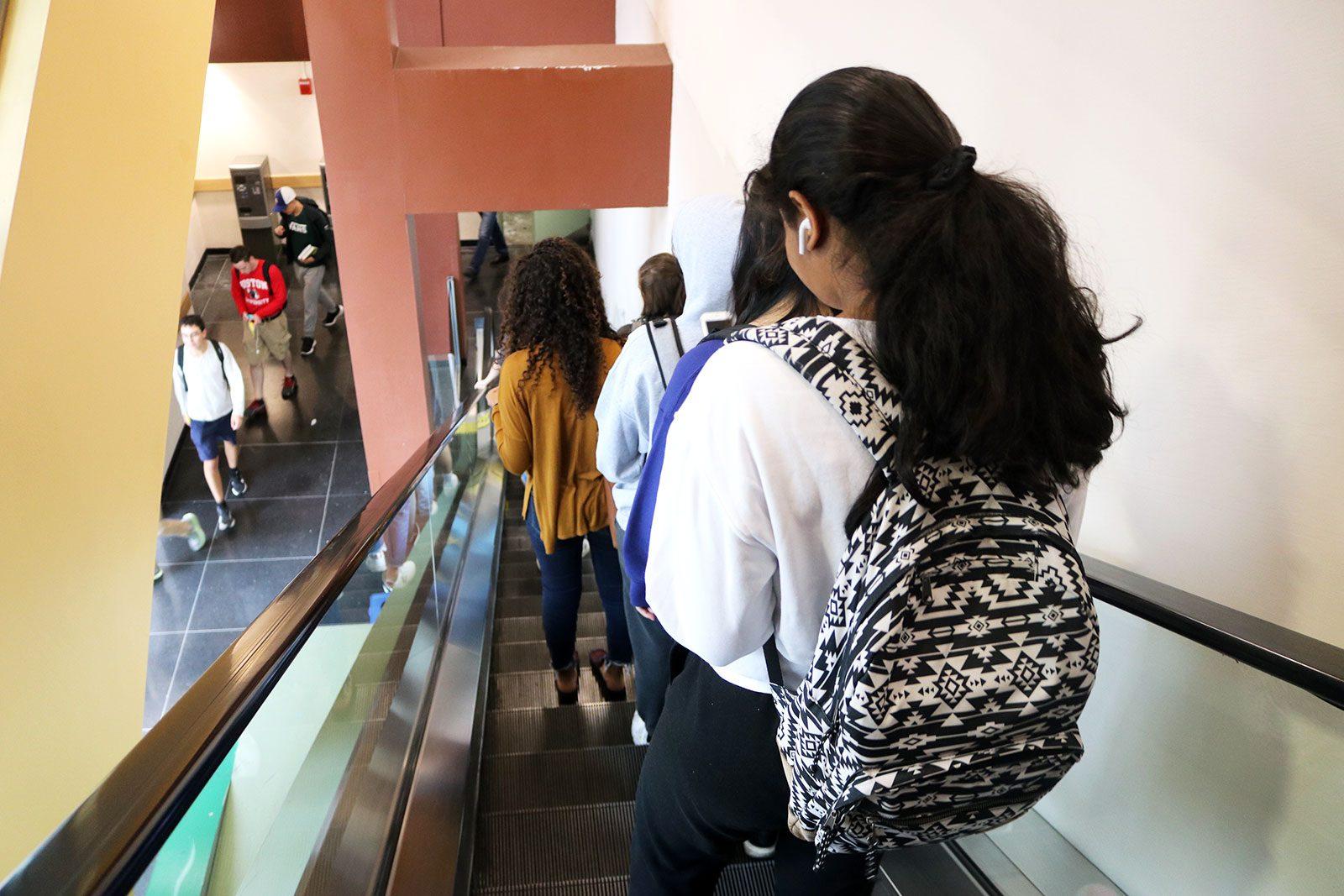 Students using the escalators below Warren Tower, which are often found out of order at various times throughout the day. LIBBY MCCLELLAN/ DAILY FREE PRESS STAFF
