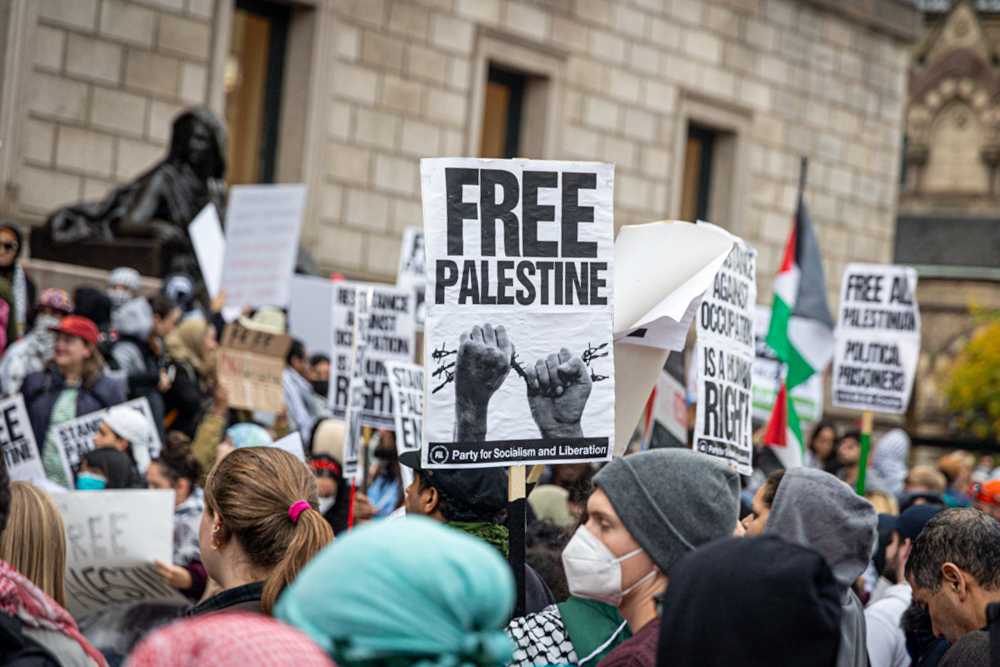 A protester displays a “Free Palestine” sign at a demonstration in front of the Boston Public Library. Hundreds of people gathered in Copley Square on Monday to show support for Palestinians amidst ongoing violence in the Middle East. JIASHAN ZHENG/ DFP PHOTOGRAPHER