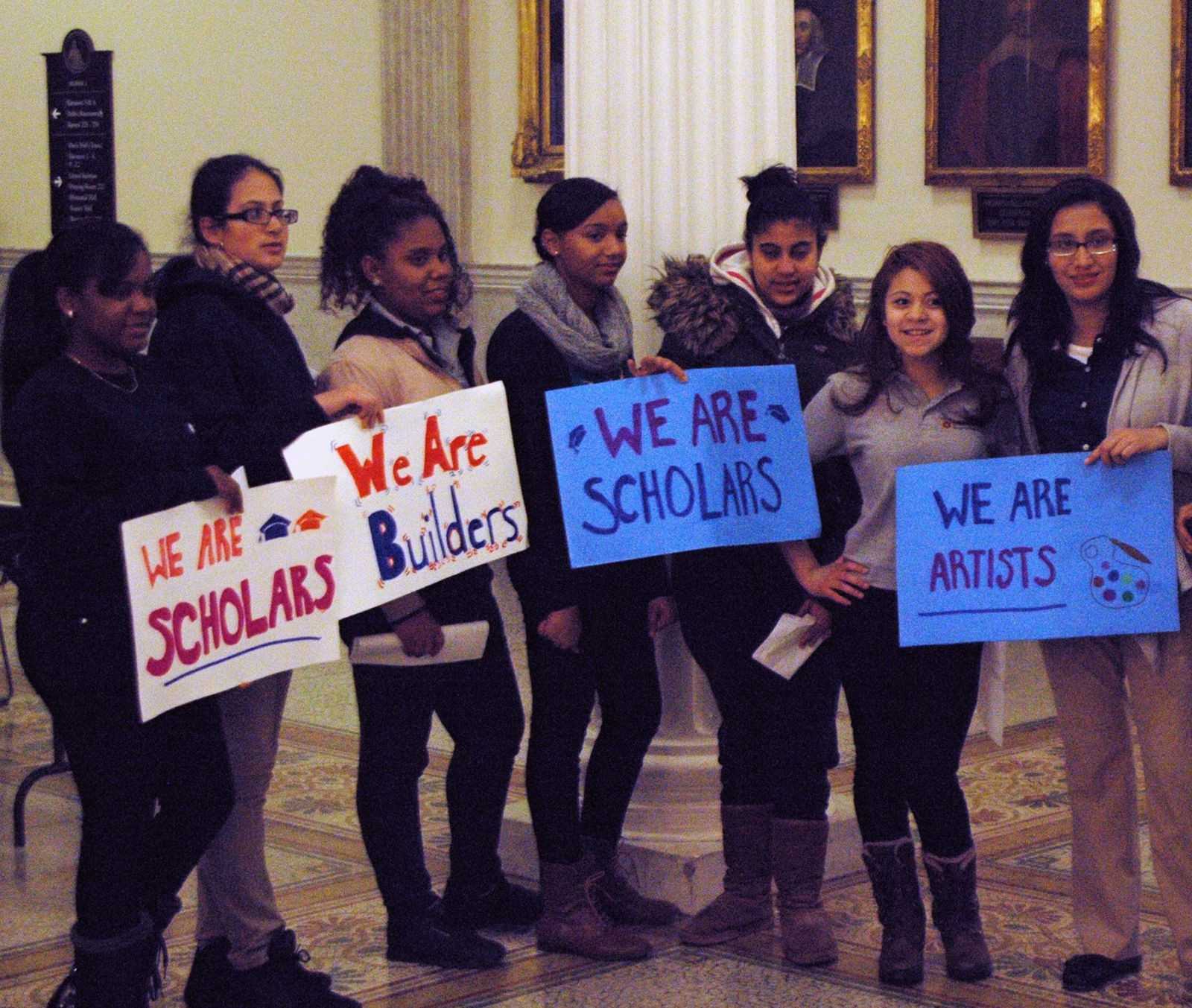 SIM supporters hold signs advocating for in-state tuition and financial aid for undocumented students.