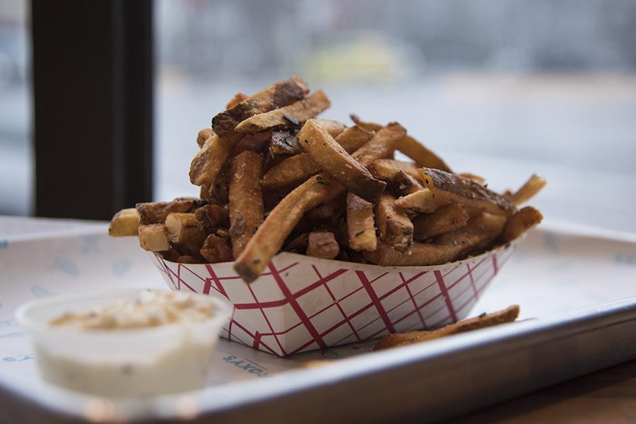The truffle fries from Roxy's, in Allston, shown with a side of truffle mayo, balanced just the right amount of crispy texture and flavor. PHOTO BY LEXI PLINE/ DAILY FREE PRESS STAFF
