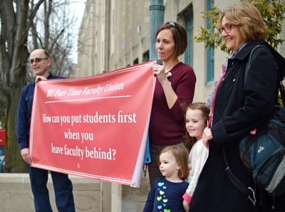 Adjunct professors stand on the steps of the College of Arts and Sciences in peaceful protest. PHOTO BY SAVANAH MACDONALD/DAILY FREE PRESS STAFF