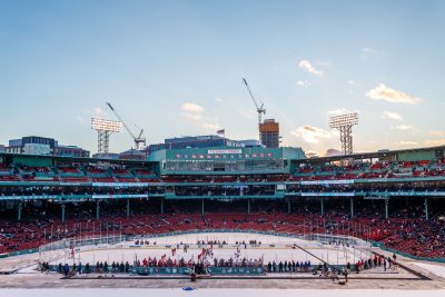 BOSTON, MA - JANUARY 07: Teams face-off against the backdrop of historic Fenway during the third period of the game between the Boston University Terriers and the UMass Minutemen on January 8th, 2016, at Fenway Park in Boston, MA. (Photo by John Kavouris/Daily Free Press Staff)