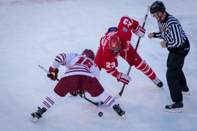 BOSTON, MA - JANUARY 07: Boston University Terriers forward Jakob Forsbacka Karlsson (23) faces off during the second period of the game between the Boston University Terriers and the UMass Minutemen on January 8th, 2016, at Fenway Park in Boston, MA. (Photo by John Kavouris/Daily Free Press Staff)