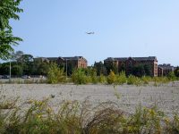 A plane flies over the site of the Dorchester Bay City project.