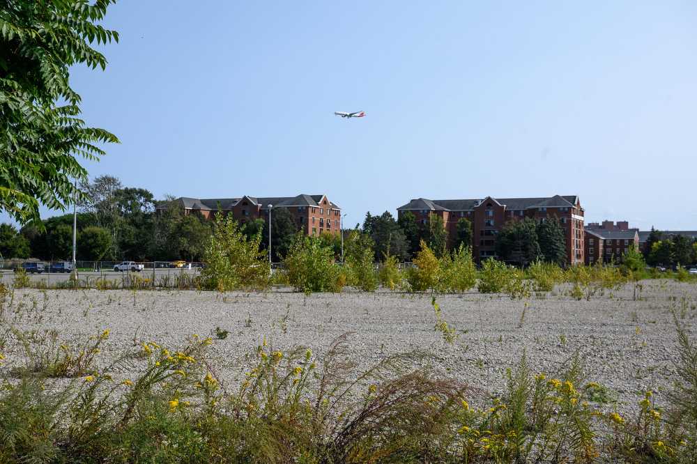 A plane flies over the site of the Dorchester Bay City project.