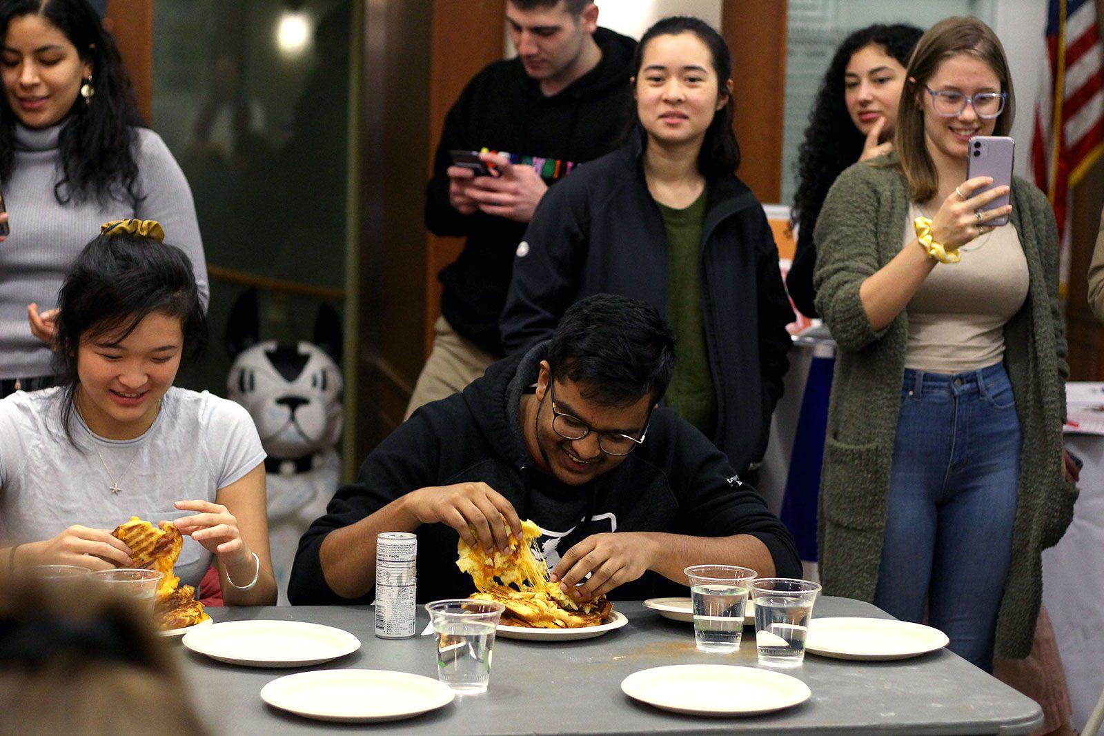 Students partake in a grilled cheese eating competition at the Boston University Hillel House Thursday. HANNAH YOSHINAGA/ DAILY FREE PRESS STAFF 