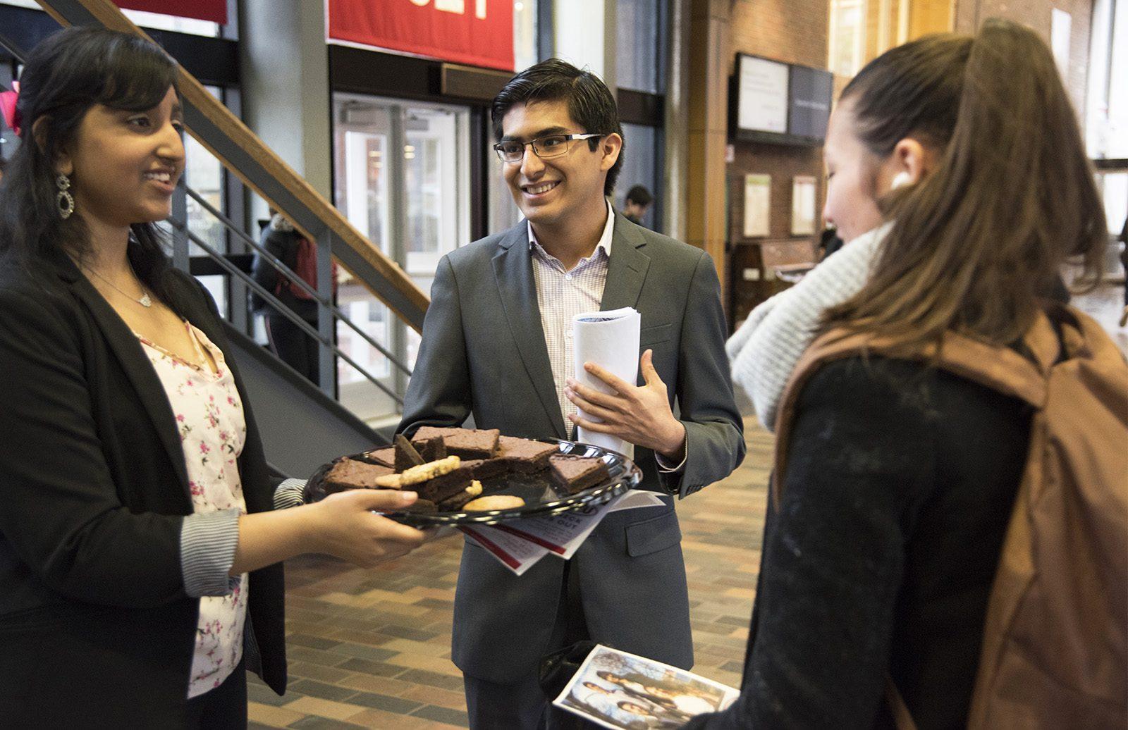 Hector Meneses (Questrom ’19) and Vaishnavi Kothapalli (CGS ’19), members of the B-TrU slate, speak to a passerby about Student Government election Monday afternoon​ ​during a meet and greet​ ​in the George Sherman Union Link. PHOTO BY LEXI PLINE/ DAILY FREE PRESS STAFF