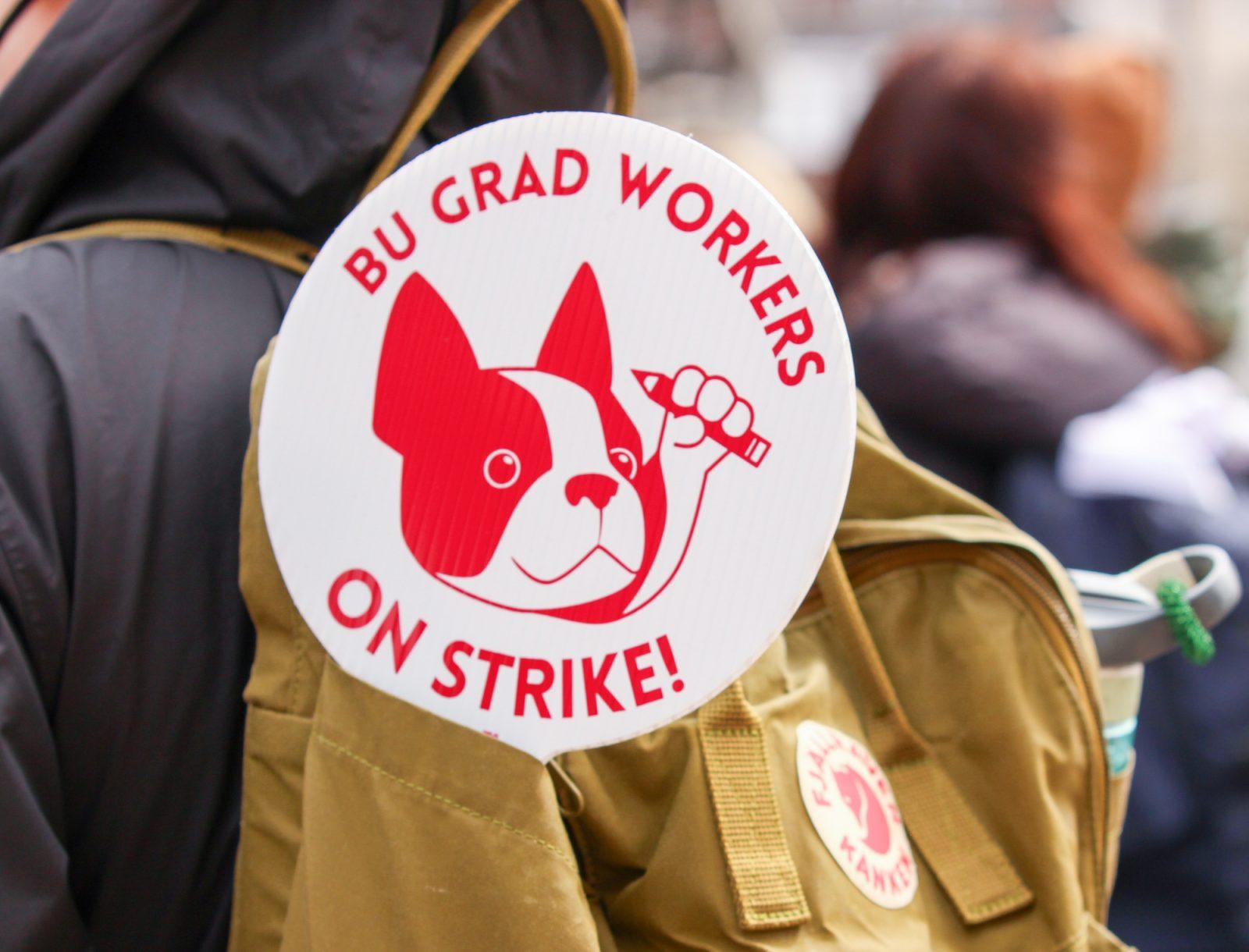 A protester with a sign supporting the Boston University Graduate Workers strike at a rally on March 25. College of Arts and Sciences Dean Stan Sclaroff emailed faculty recommending the use of artificial intelligence to assist with classes while graduate teaching assistants are on strike. BRENDA GONZALEZ/DFP PHOTOGRAPHER