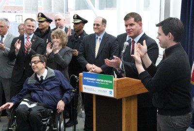 Boston Mayor Martin Walsh speaks about the greater accessibility for disabled customers alongside a disabled rider. PHOTO BY SOFIA FARENTINOS/DAILY FREE PRESS STAFF