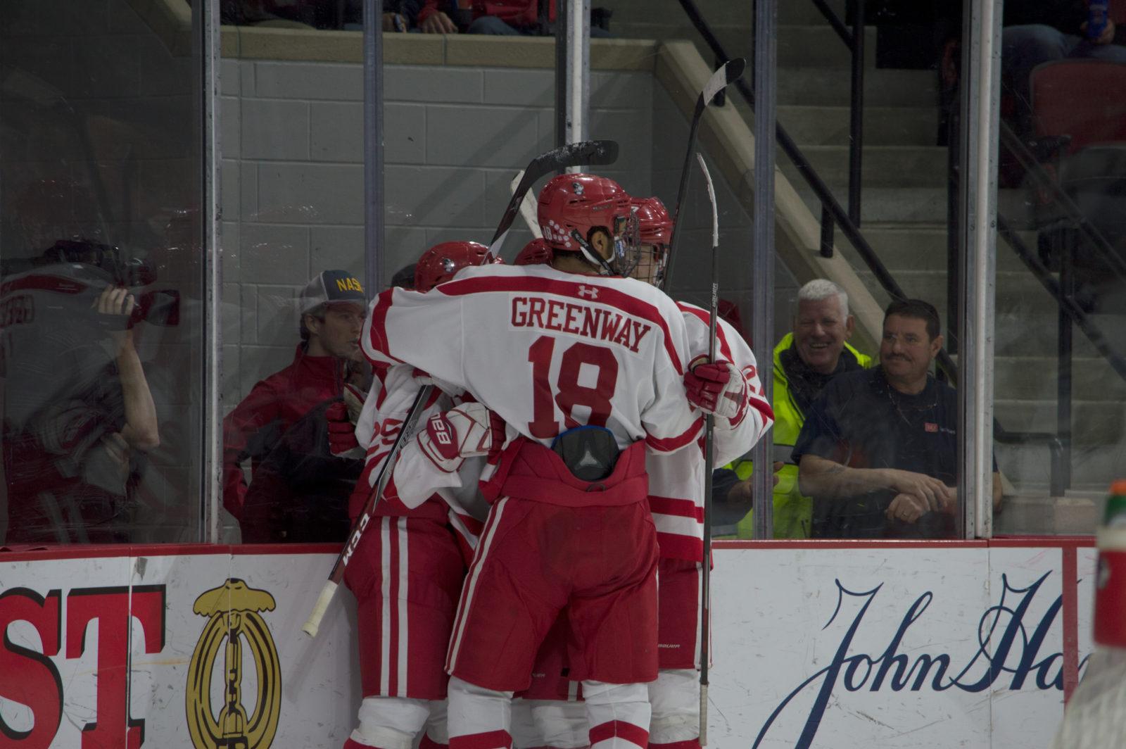 Junior forward Jordan Greenway celebrates with his teammates after scoring his third goal of the season. PHOTO BY VIGUNTHAAN THARMARAJAH/ DAILY FREE PRESS STAFF