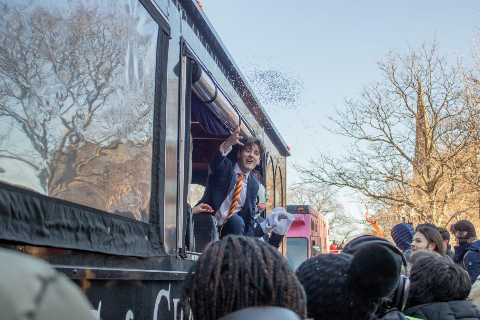 A man throws rice from a “Just Married” themed parade car. HOLLY GUSTAVSEN/DFP PHOTOGRAPHER 
