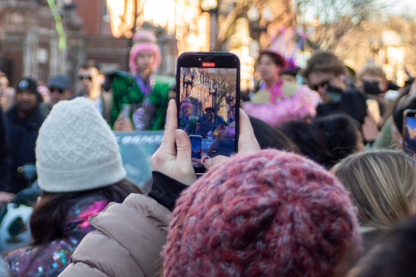 A parade attendee takes a video of Cynthia Erivo as she passes by. HOLLY GUSTAVSEN/DFP PHOTOGRAPHER 
