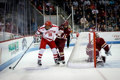 BOSTON, MA - JANUARY 13: Boston University Terriers forward Jordan Greenway (18) shoulders Boston College Eagles defenseman Scott Savage (2) away to maintain possession of the puck during the first period of the game between the Boston College Eagles and the Boston University Terriers on January 13th, 2016 at Agganis Arena in Boston, MA. (Photo by John Kavouris/Daily Free Press Staff)