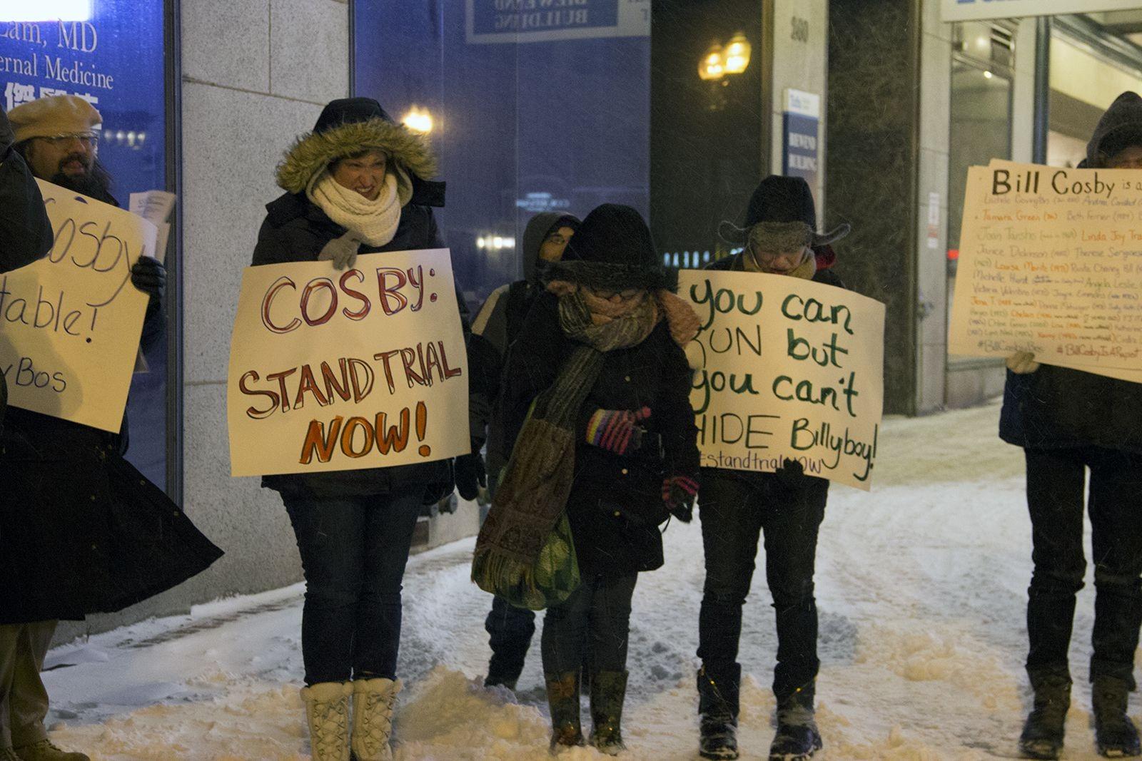Attendees gather in front of the Wilbur Theatre Sunday night in response to a performance by Bill Cosby scheduled to happen there. PHOTO BY MARY SCHLICHTE/DAILY FREE PRESS STAFF