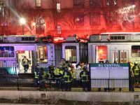 Firefighters gathered outside a an MBTA train car