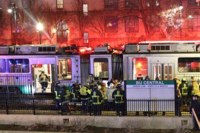 Firefighters gathered outside a an MBTA train car