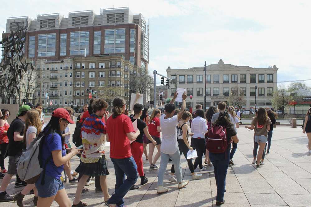 Students participate in a walkout in support of tour guides on Friday afternoon. PHOTO BY MAGGIE LEONE/DAILY FREE PRESS STAFF 