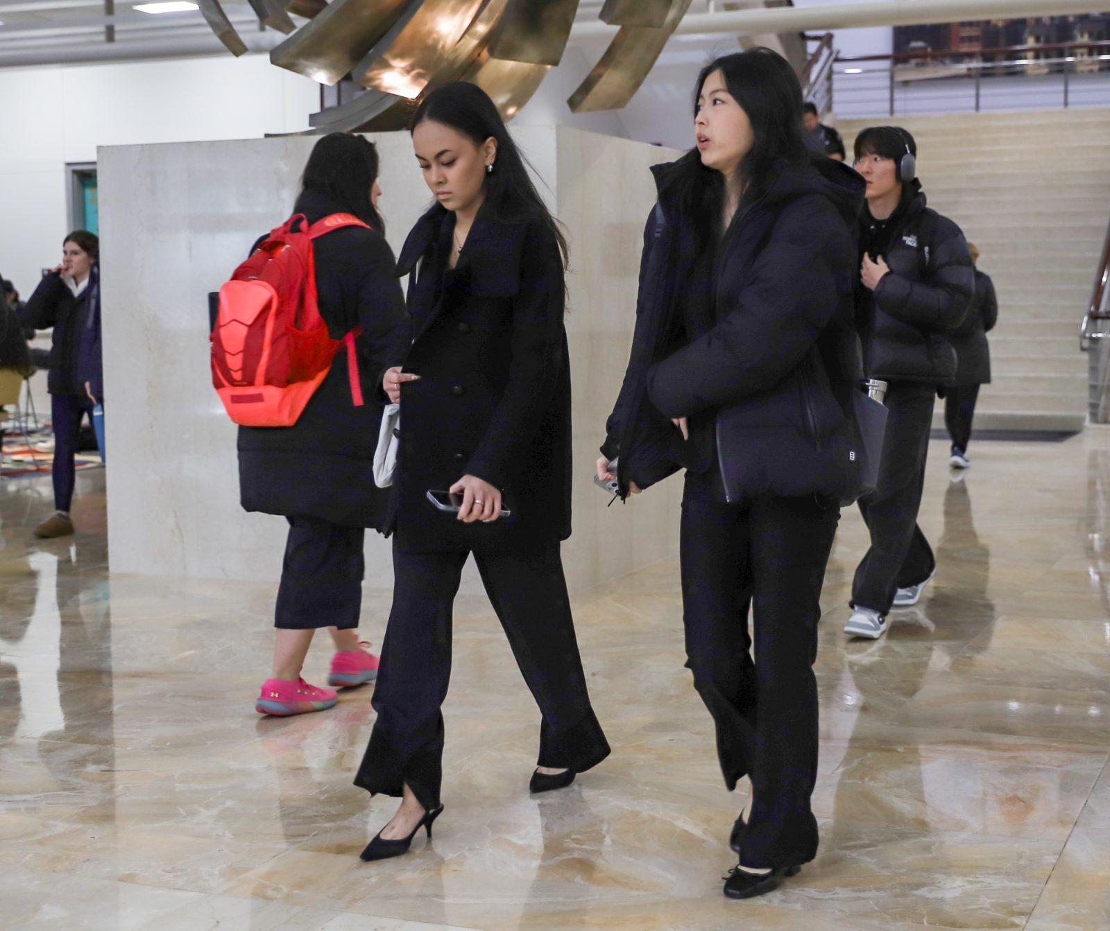 Students walking through the Questrom School of Business in professional attire. Many Questrom professors require students to wear business attire for their presentations. KATE KOTLYAR/DFP PHOTOGRAPHER 