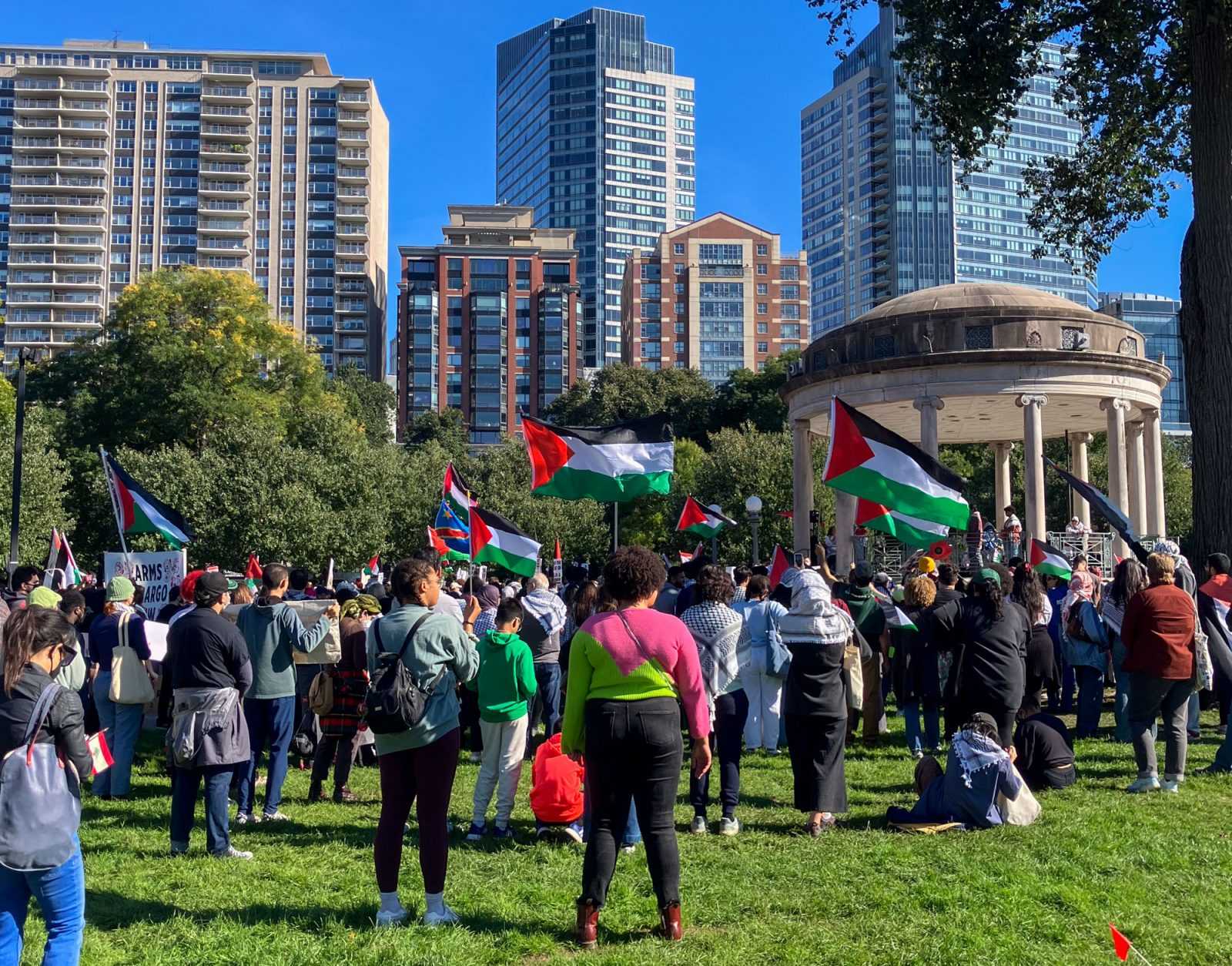 People wave Palestinian flags during a rally organized by the Boston Coalition for Palestine. PHOTO BY LEIA GREEN