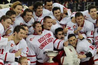 Members of the BU men's hockey team celebrate winning the Kelley-Harkness Trophy over Cornell. PHOTO BY JUDY COHEN/DAILY FREE PRESS STAFF