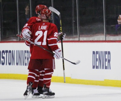 Seniors Mike Moran and Matt Lane hug before stepping off the ice after BU's loss to Denver. PHOTO BY JUDY COHEN/DAILY FREE PRESS STAFF